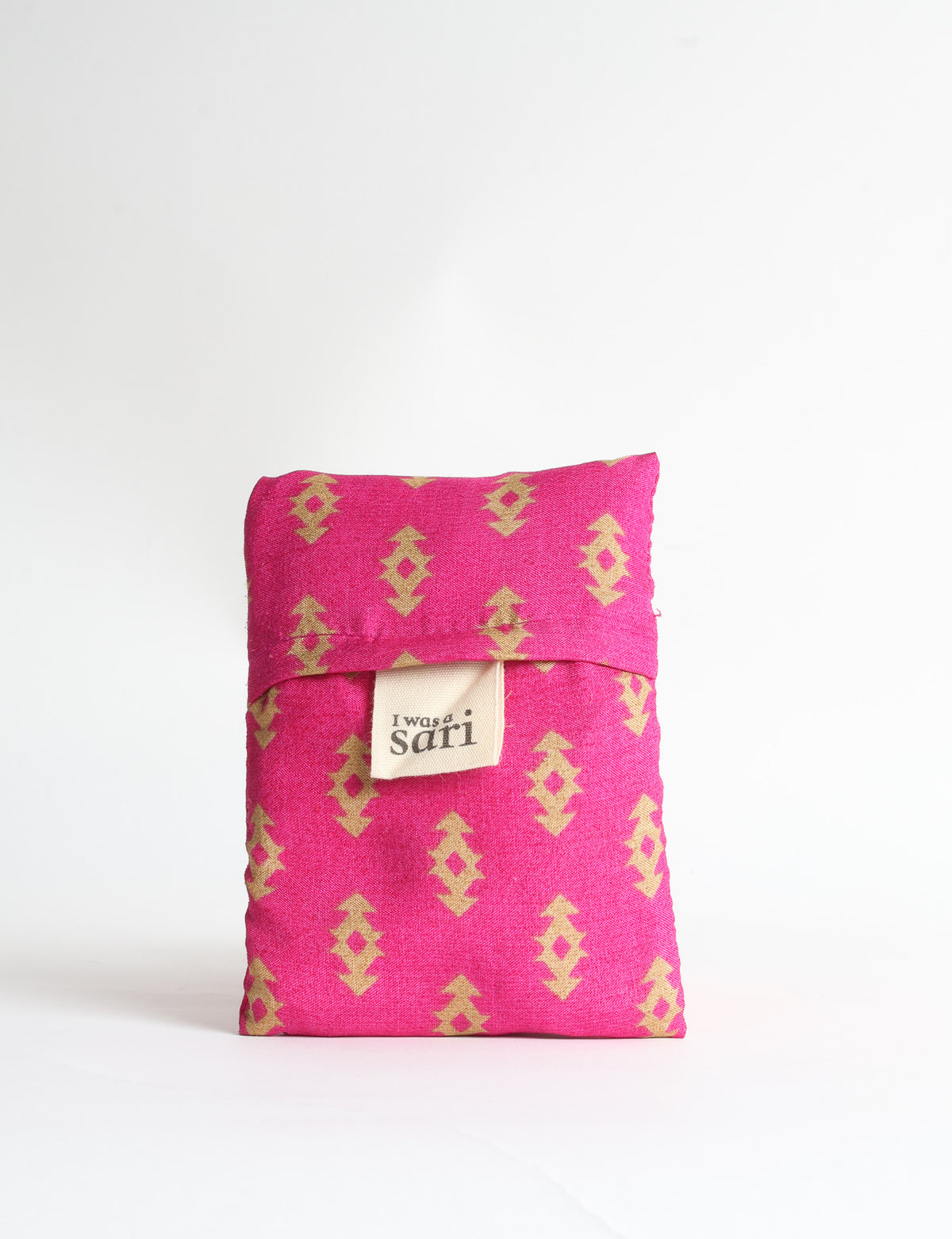 Blue reusable bag with tropical floral pattern in pink, yellow, and green, shown hanging with handles visible