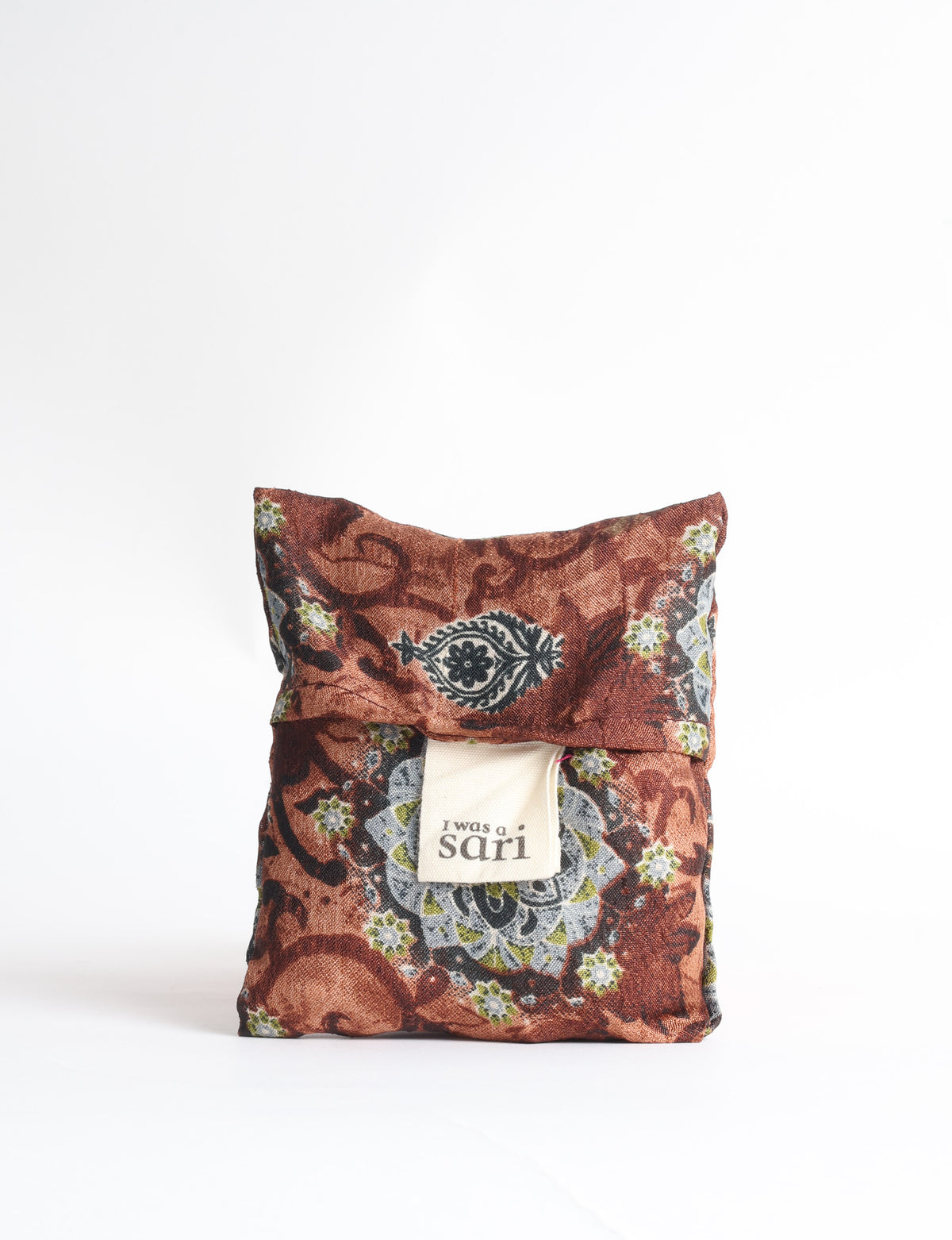 Blue reusable bag with tropical floral pattern in pink, yellow, and green, shown hanging with handles visible