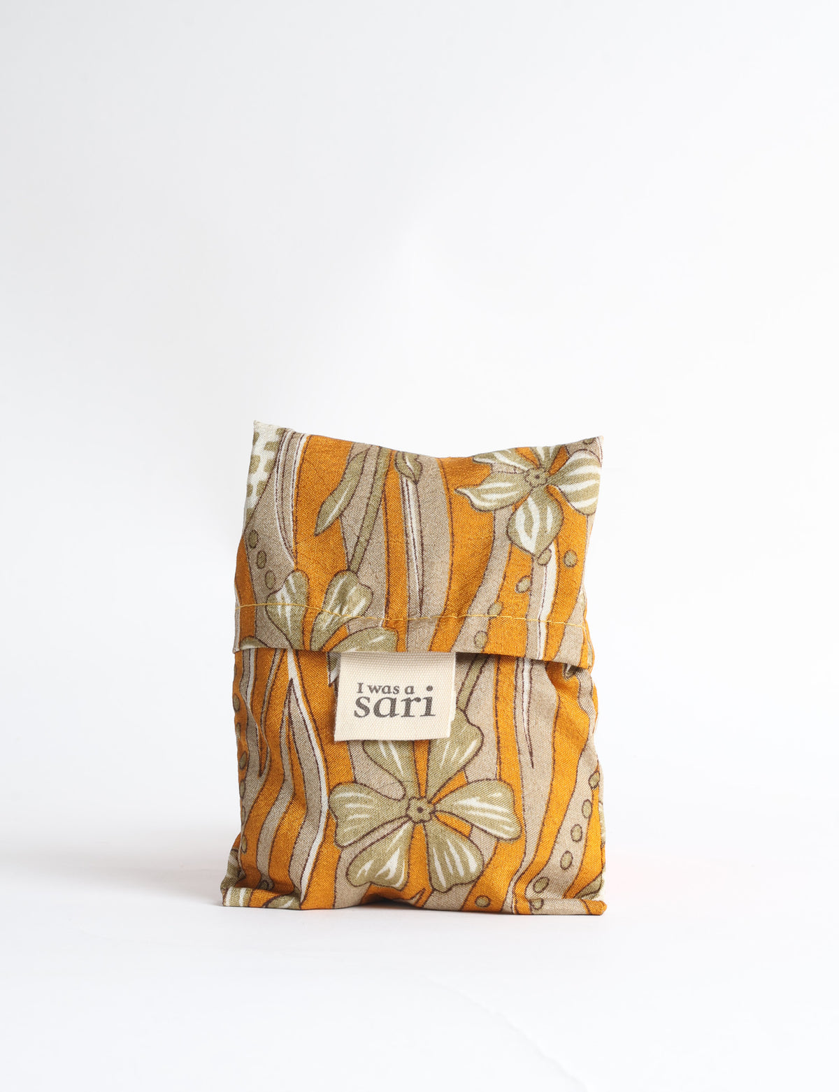 Blue reusable bag with tropical floral pattern in pink, yellow, and green, shown hanging with handles visible