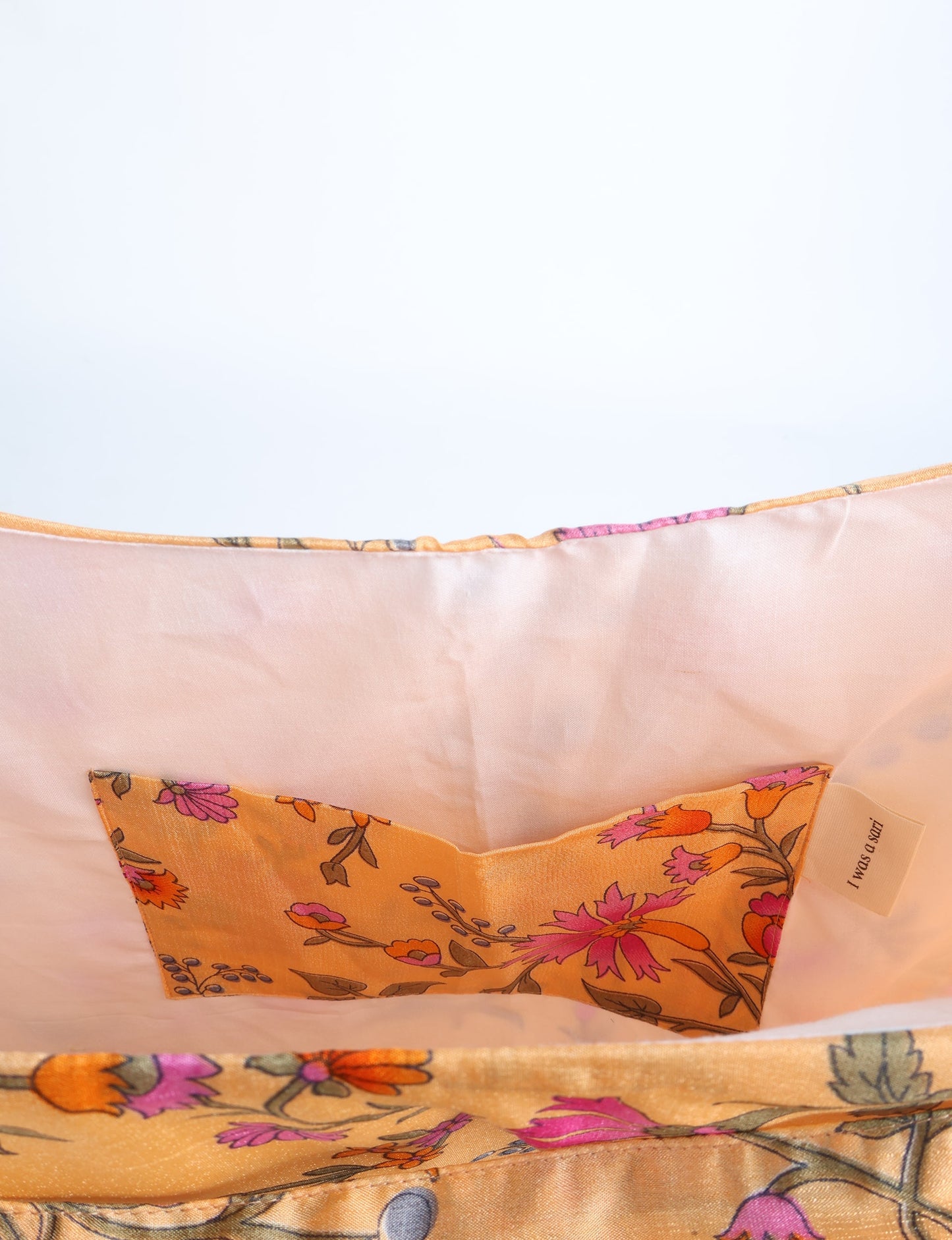 Trapeze bag made from repurposed sari fabric, featuring bold patterns and eco friendly cloth design—part of a sustainable women's clothing collection.