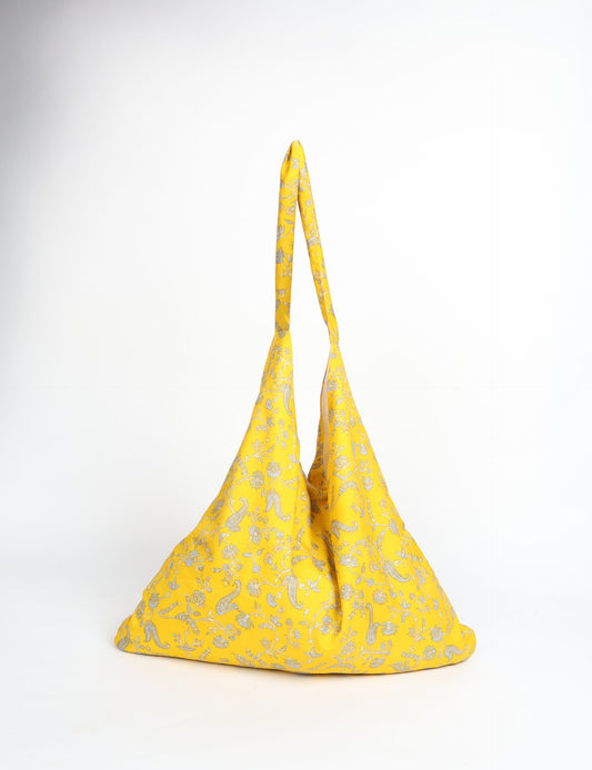 Trapeze bag made from repurposed sari fabric, featuring bold patterns and eco friendly cloth design—part of a sustainable women's clothing collection.