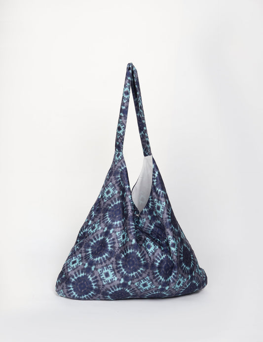Trapeze bag made from repurposed sari fabric, featuring bold patterns and eco friendly cloth design—part of a sustainable women's clothing collection.