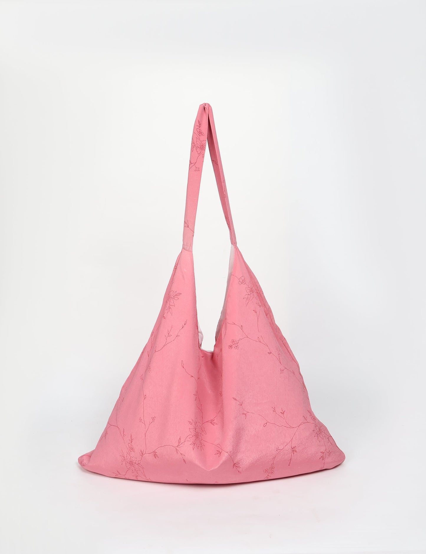 Trapeze bag made from repurposed sari fabric, featuring bold patterns and eco friendly cloth design—part of a sustainable women's clothing collection.