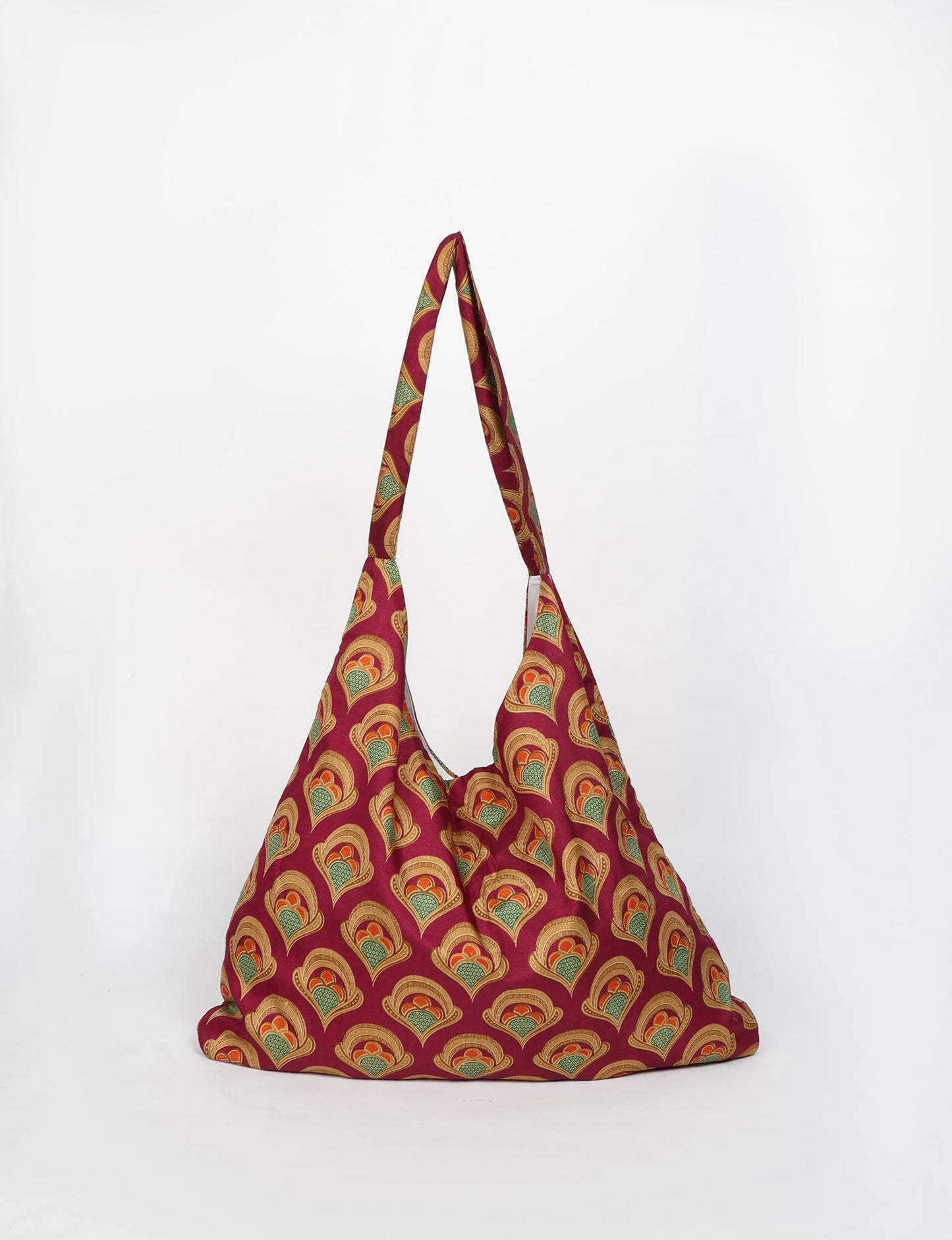 Trapeze bag made from repurposed sari fabric, featuring bold patterns and eco friendly cloth design—part of a sustainable women's clothing collection.