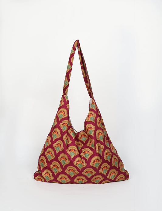 Trapeze bag made from repurposed sari fabric, featuring bold patterns and eco friendly cloth design—part of a sustainable women's clothing collection.