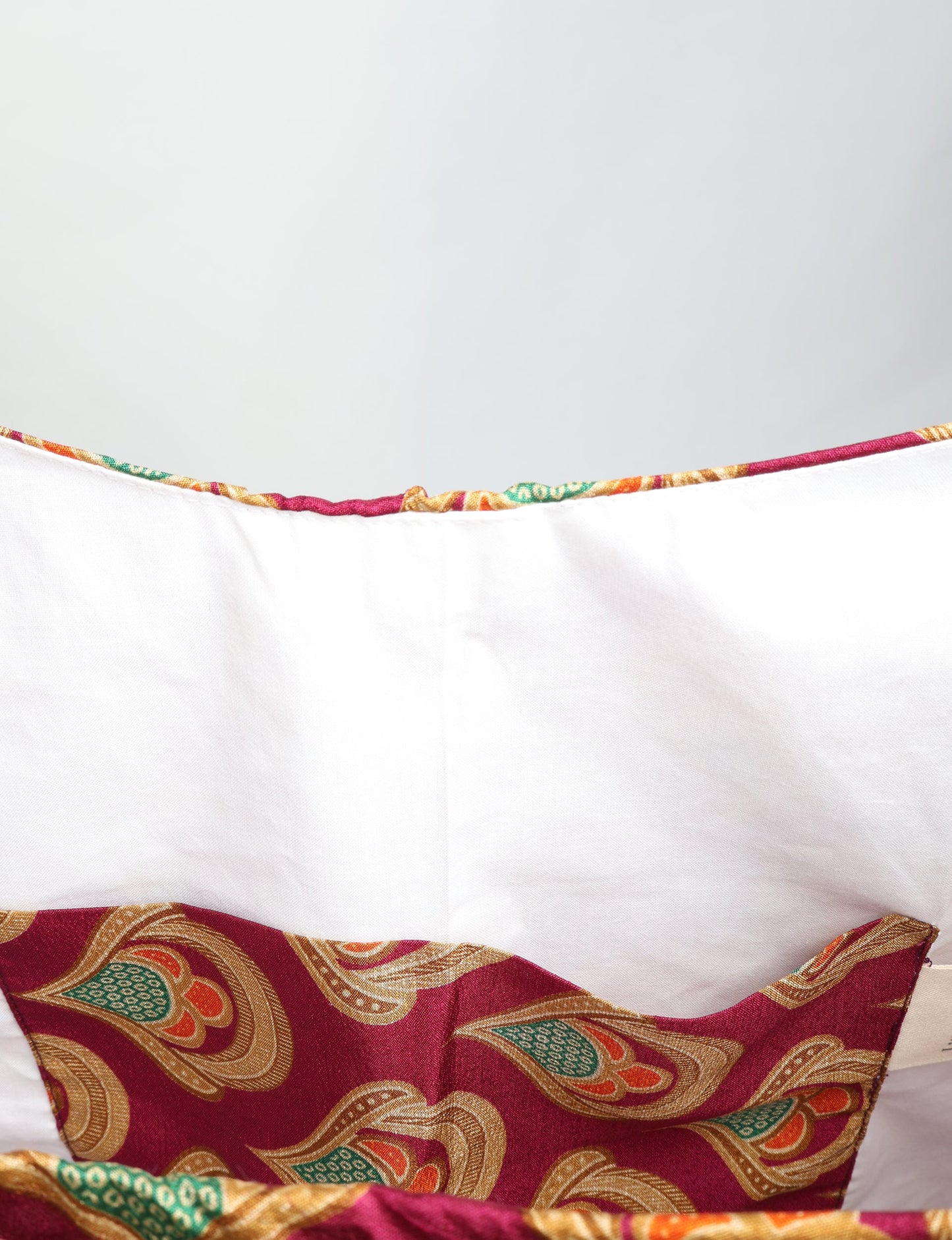 Trapeze bag made from repurposed sari fabric, featuring bold patterns and eco friendly cloth design—part of a sustainable women's clothing collection.