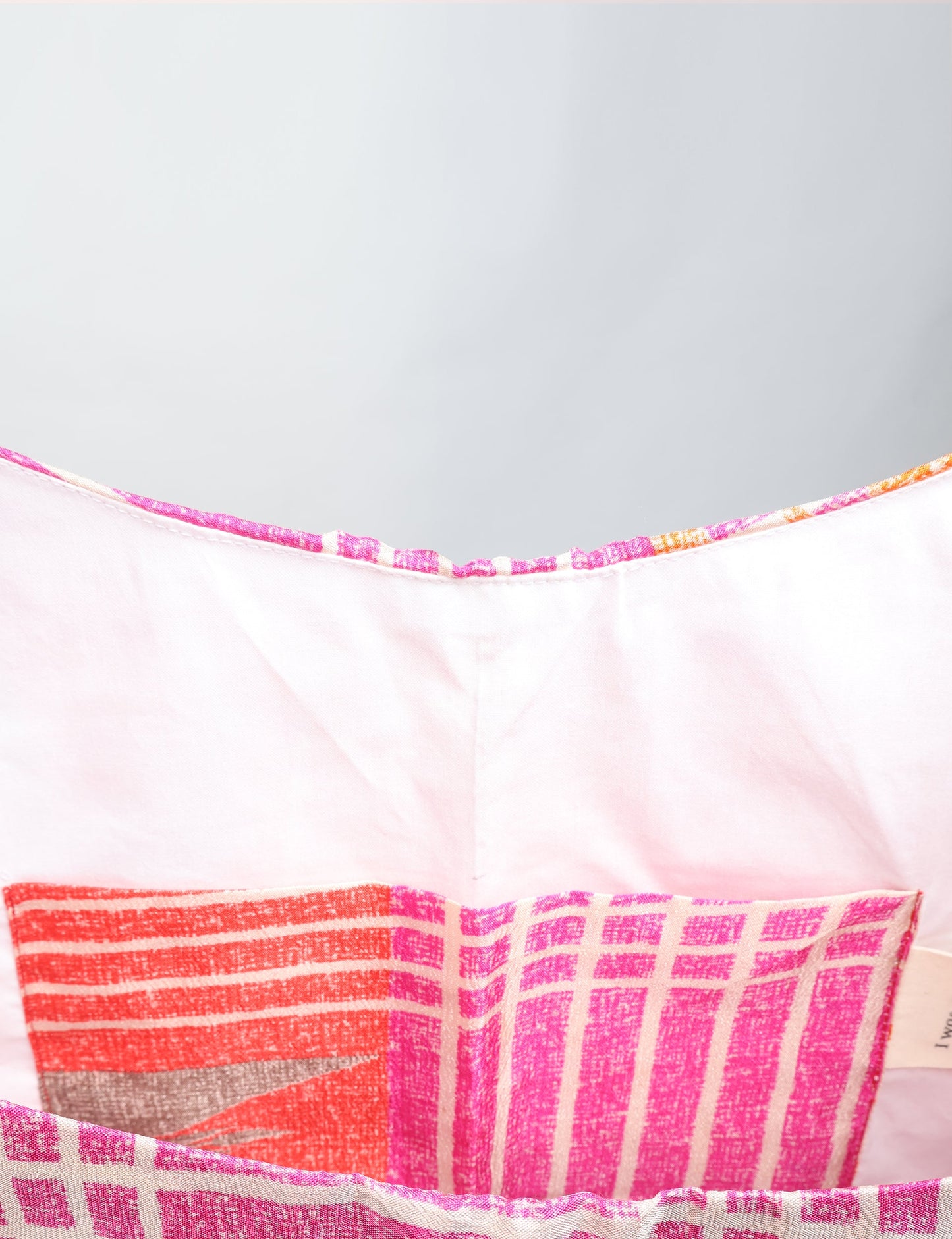 Trapeze bag made from repurposed sari fabric, featuring bold patterns and eco friendly cloth design—part of a sustainable women's clothing collection.