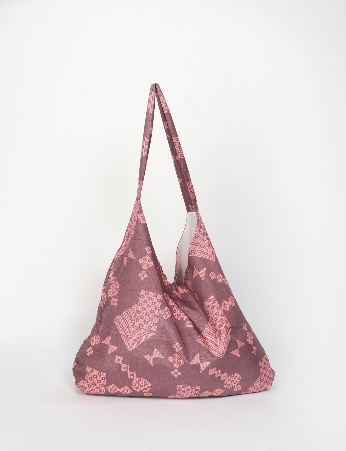 Trapeze bag made from repurposed sari fabric, featuring bold patterns and eco friendly cloth design—part of a sustainable women's clothing collection.