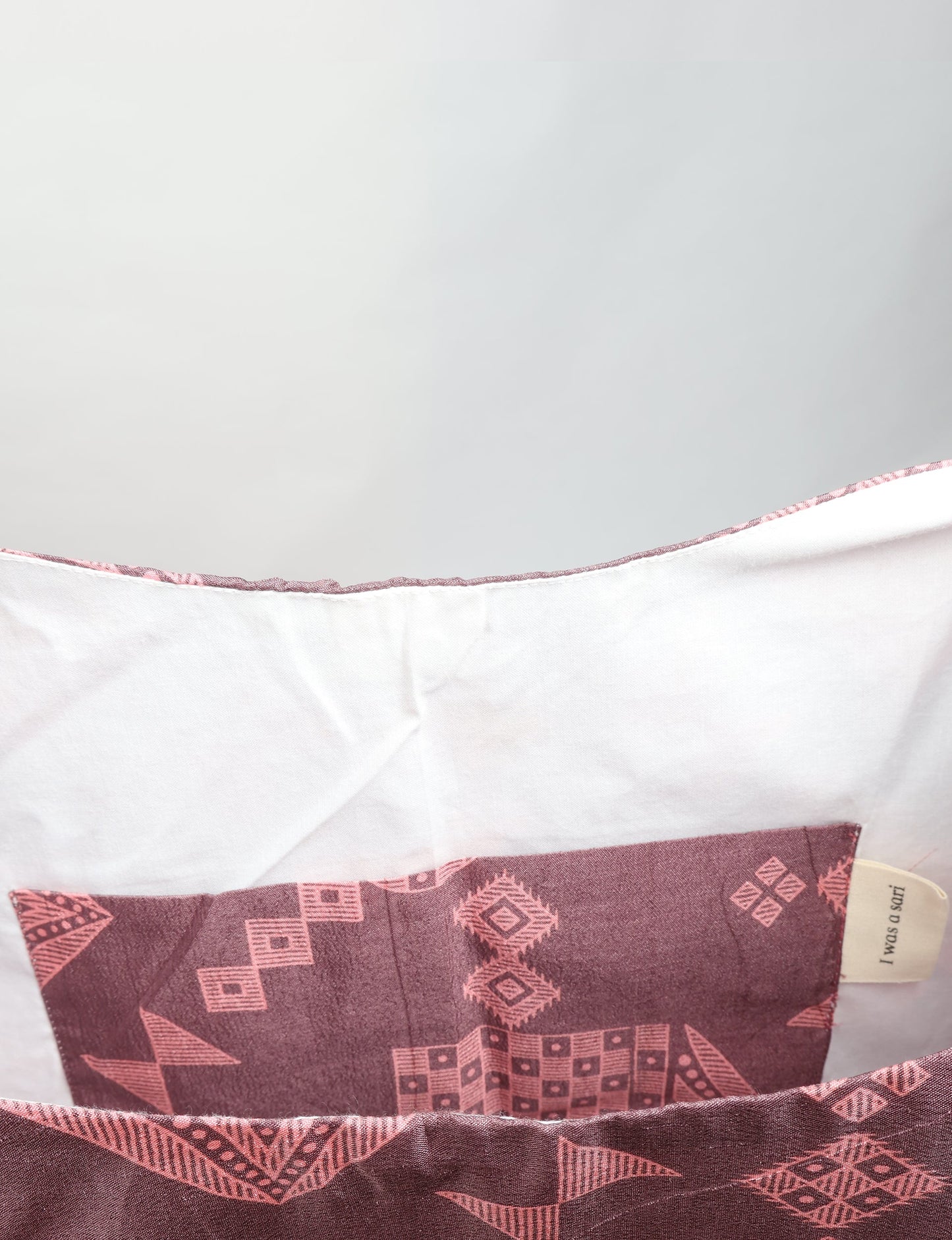 Trapeze bag made from repurposed sari fabric, featuring bold patterns and eco friendly cloth design—part of a sustainable women's clothing collection.