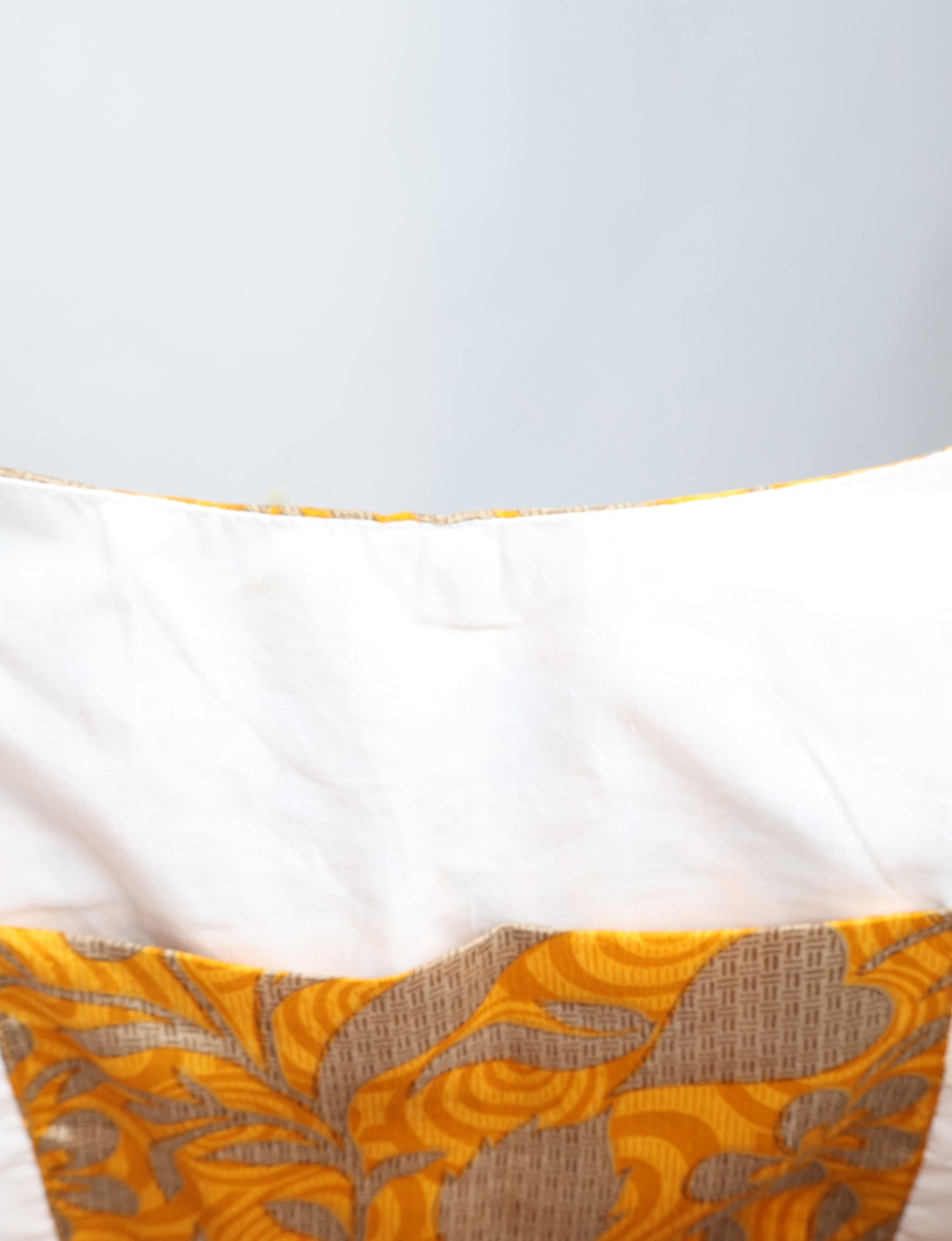 Trapeze bag made from repurposed sari fabric, featuring bold patterns and eco friendly cloth design—part of a sustainable women's clothing collection.