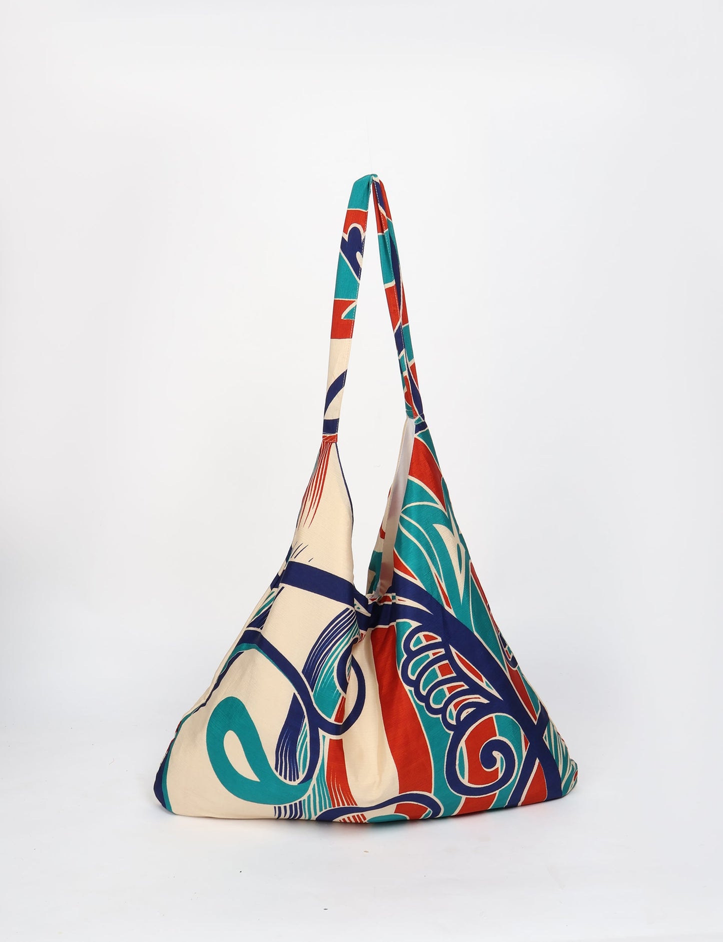 Trapeze bag made from repurposed sari fabric, featuring bold patterns and eco friendly cloth design—part of a sustainable women's clothing collection.