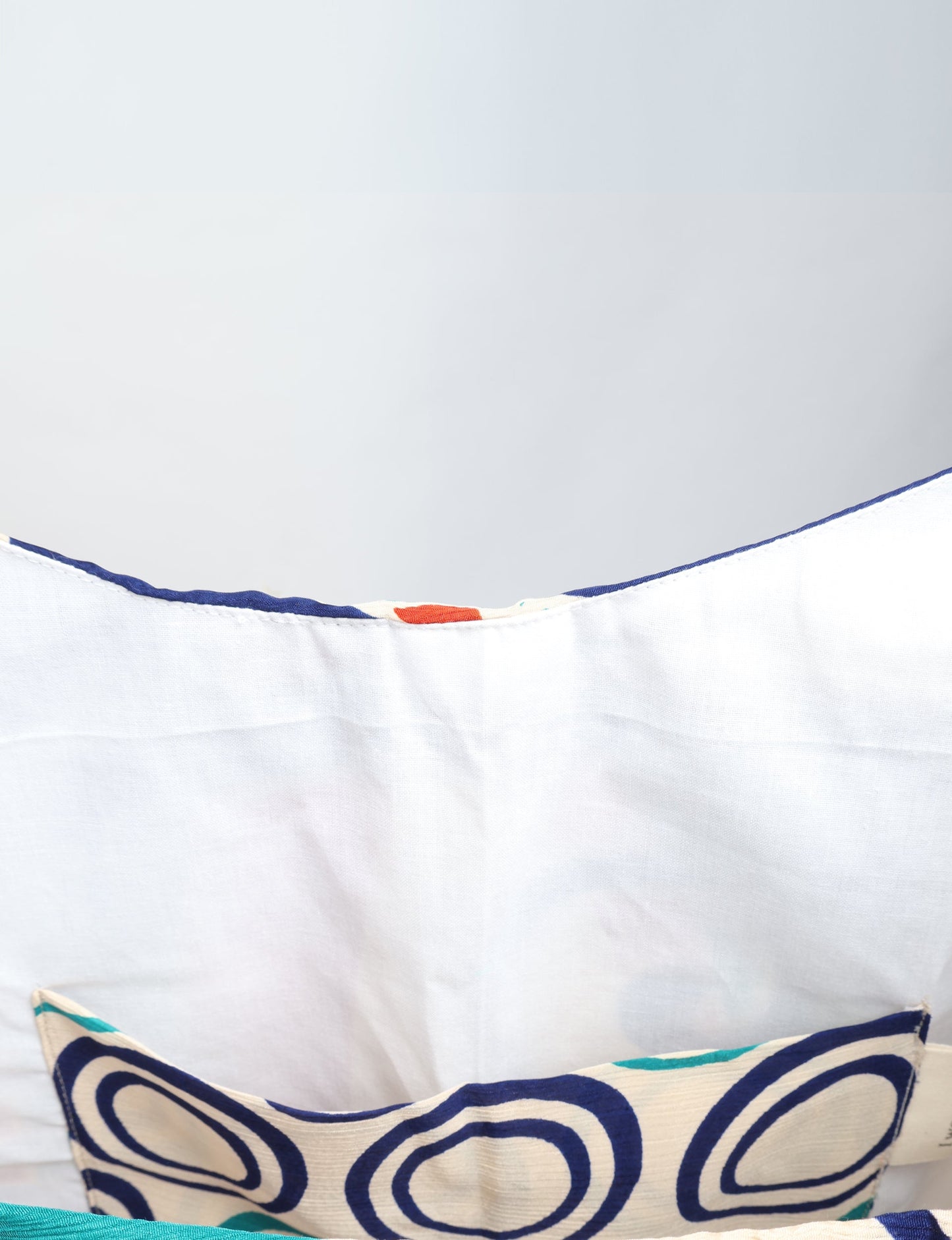 Trapeze bag made from repurposed sari fabric, featuring bold patterns and eco friendly cloth design—part of a sustainable women's clothing collection.