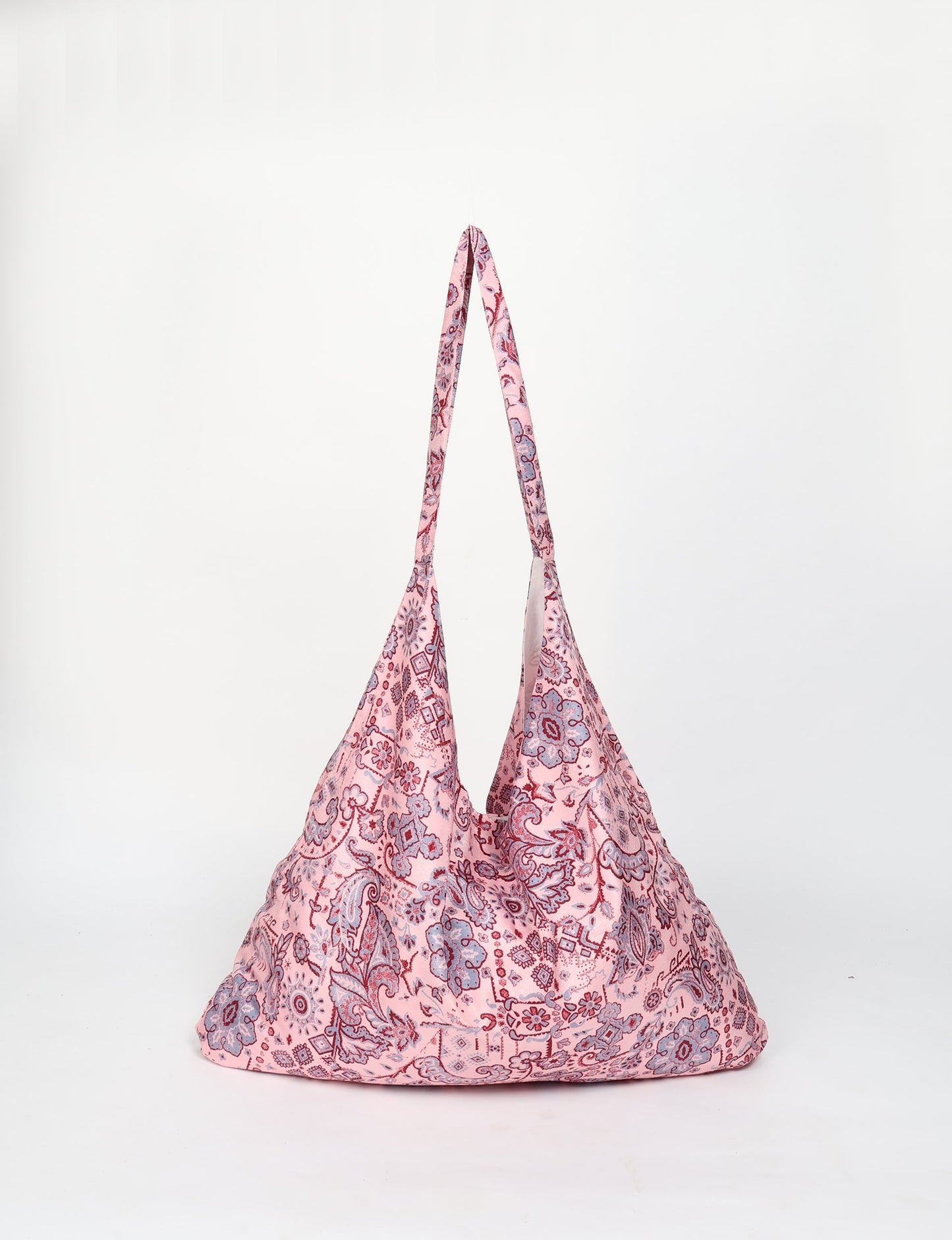 Trapeze bag made from repurposed sari fabric, featuring bold patterns and eco friendly cloth design—part of a sustainable women's clothing collection.