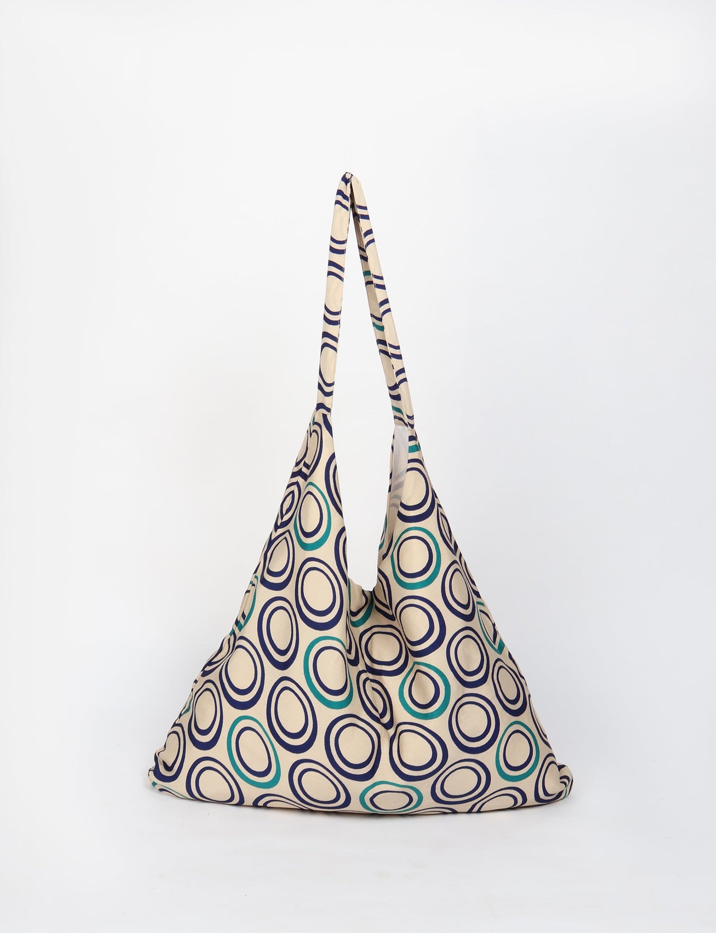 Trapeze bag made from repurposed sari fabric, featuring bold patterns and eco friendly cloth design—part of a sustainable women's clothing collection.