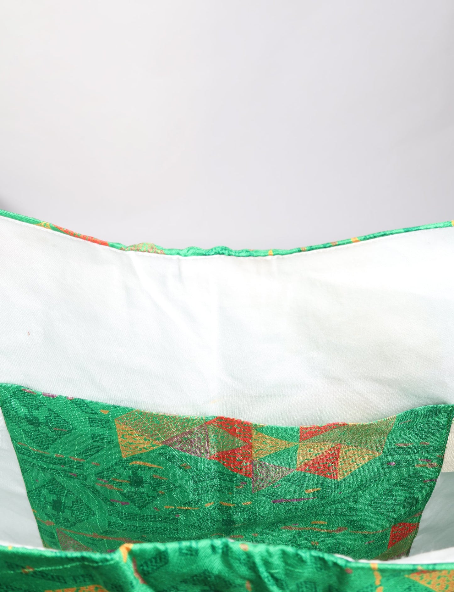 Trapeze bag made from repurposed sari fabric, featuring bold patterns and eco friendly cloth design—part of a sustainable women's clothing collection.
