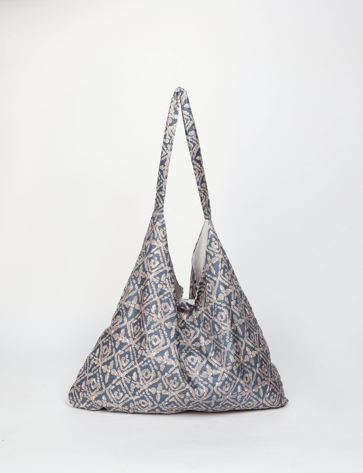 Trapeze bag made from repurposed sari fabric, featuring bold patterns and eco friendly cloth design—part of a sustainable women's clothing collection.