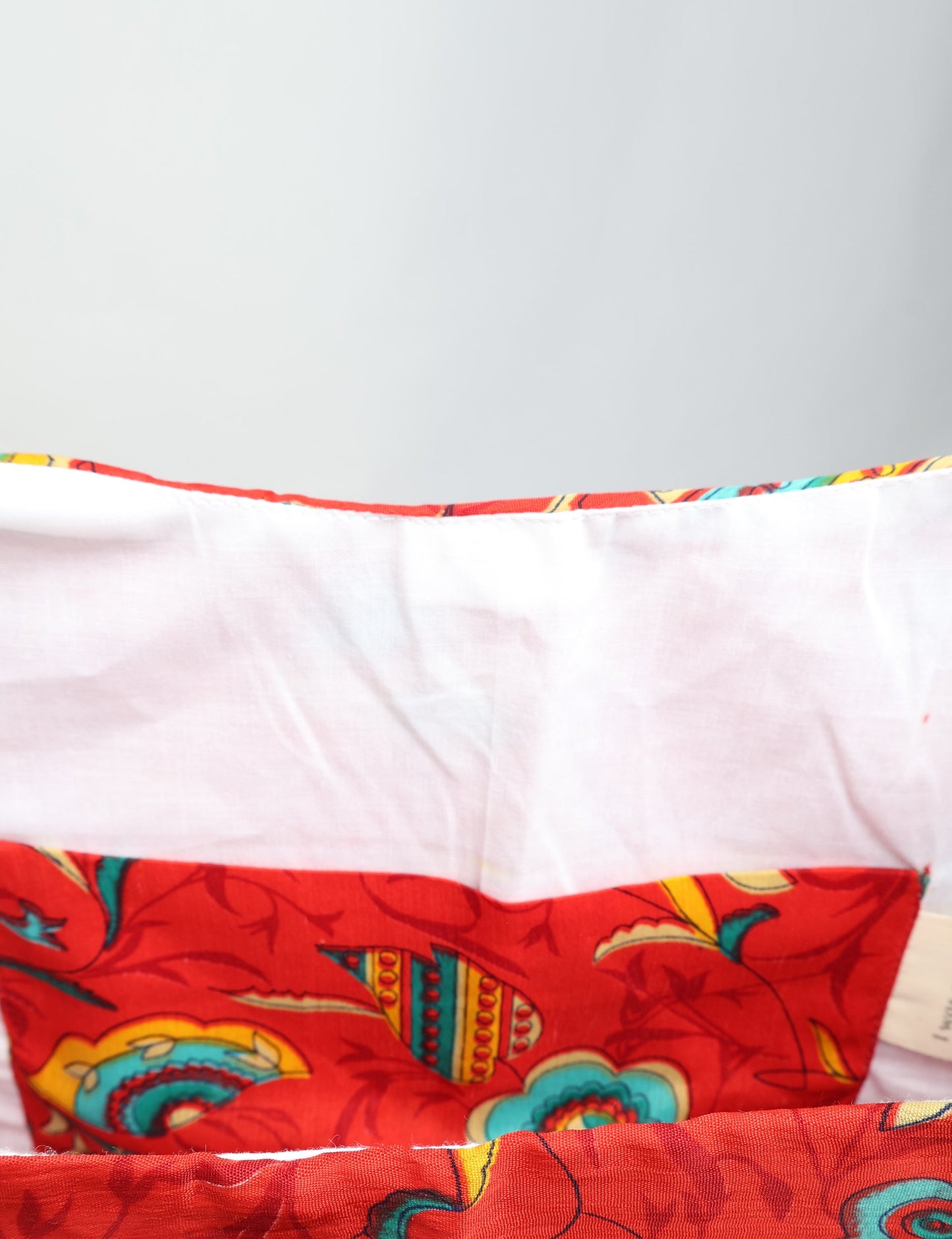 Trapeze bag made from repurposed sari fabric, featuring bold patterns and eco friendly cloth design—part of a sustainable women's clothing collection.