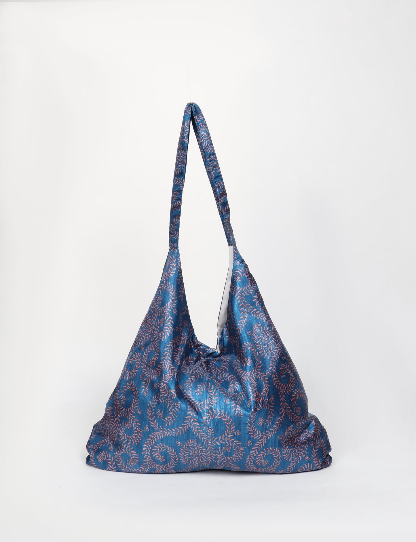 Trapeze bag made from repurposed sari fabric, featuring bold patterns and eco friendly cloth design—part of a sustainable women's clothing collection.