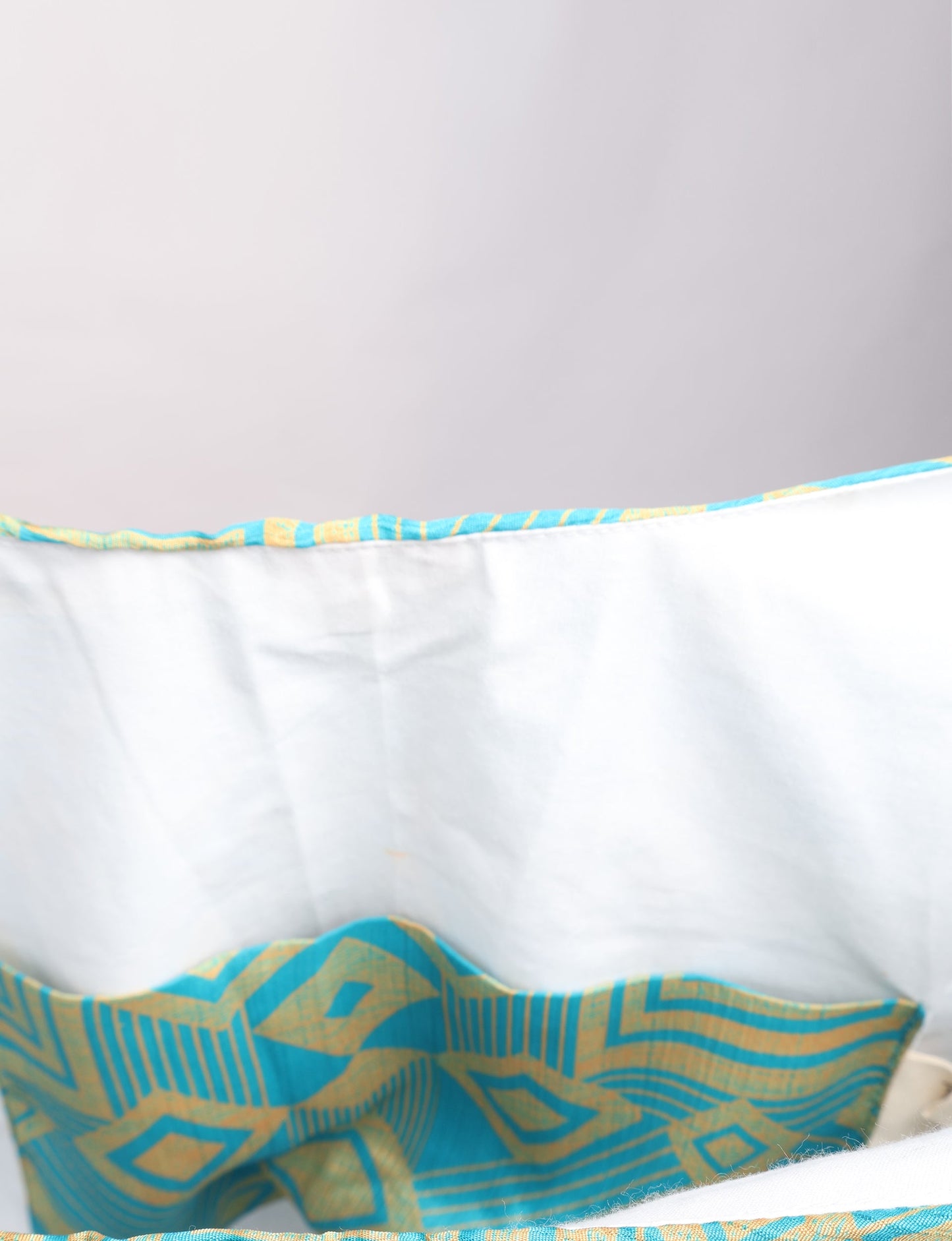 Trapeze bag made from repurposed sari fabric, featuring bold patterns and eco friendly cloth design—part of a sustainable women's clothing collection.