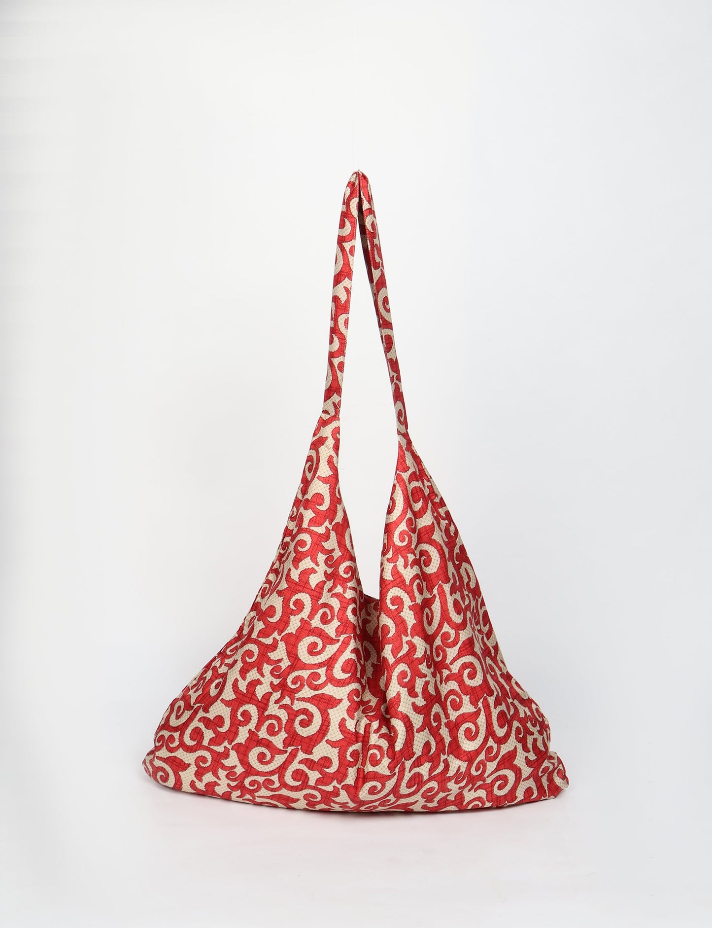 Trapeze bag made from repurposed sari fabric, featuring bold patterns and eco friendly cloth design—part of a sustainable women's clothing collection.