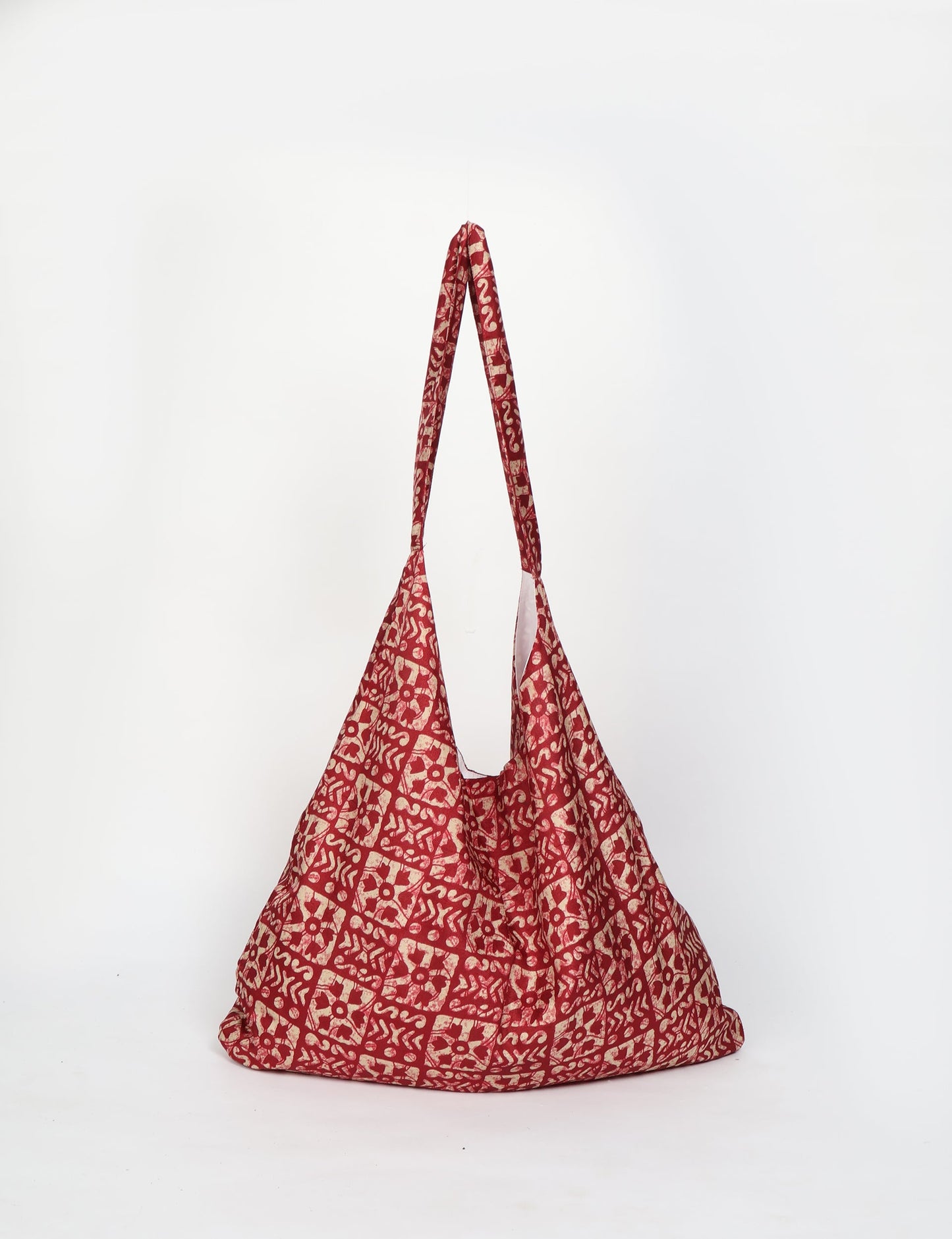 Trapeze bag made from repurposed sari fabric, featuring bold patterns and eco friendly cloth design—part of a sustainable women's clothing collection.