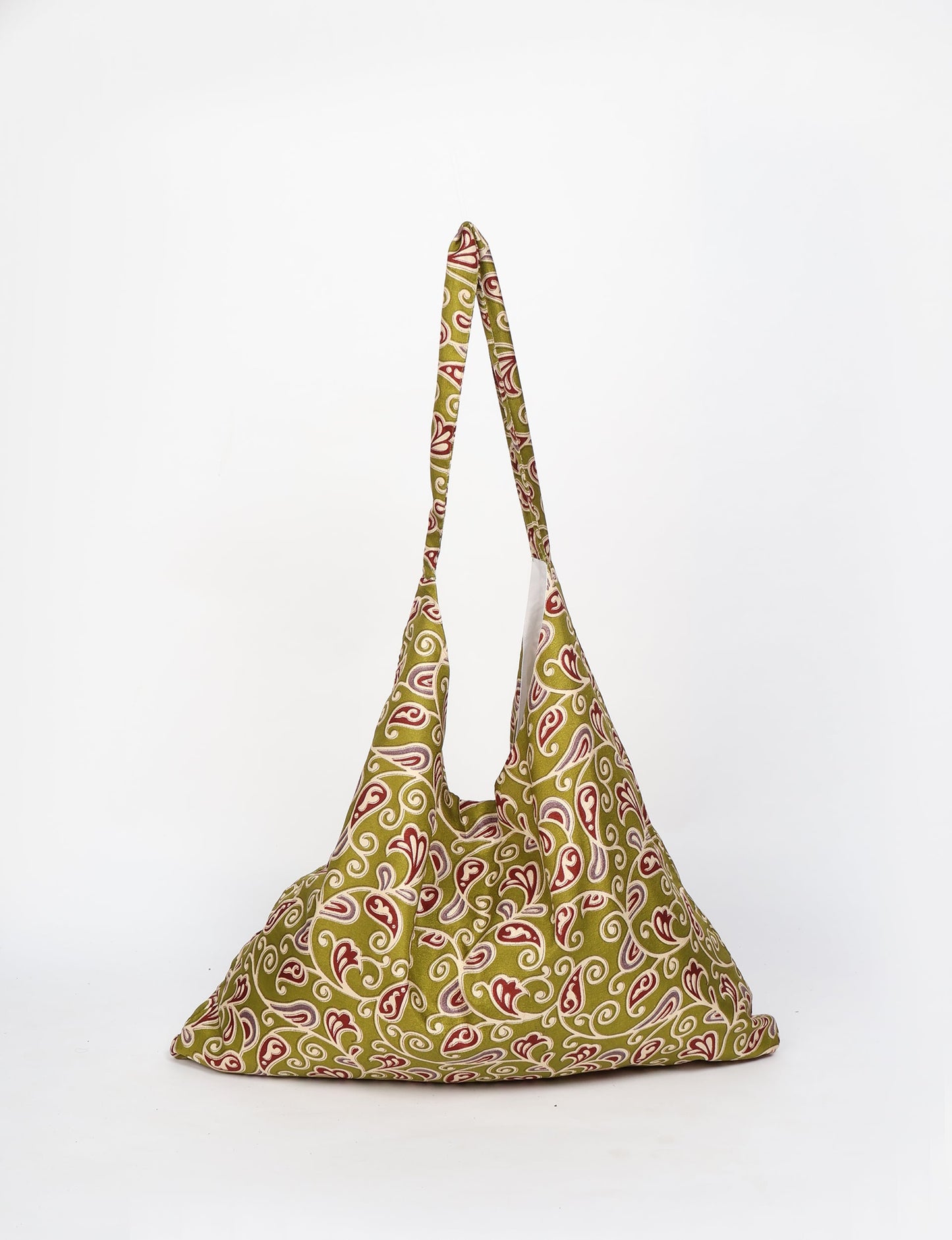 Trapeze bag made from repurposed sari fabric, featuring bold patterns and eco friendly cloth design—part of a sustainable women's clothing collection.