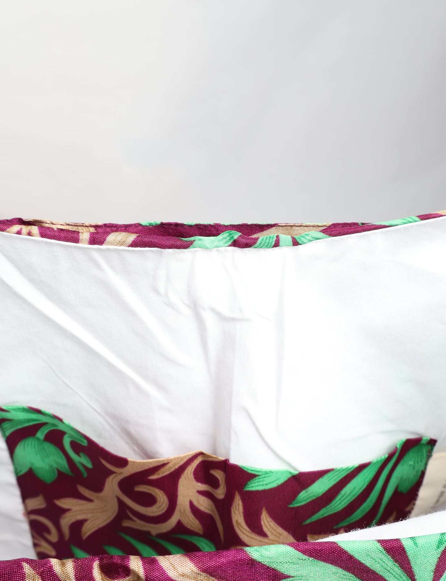 Trapeze bag made from repurposed sari fabric, featuring bold patterns and eco friendly cloth design—part of a sustainable women's clothing collection.