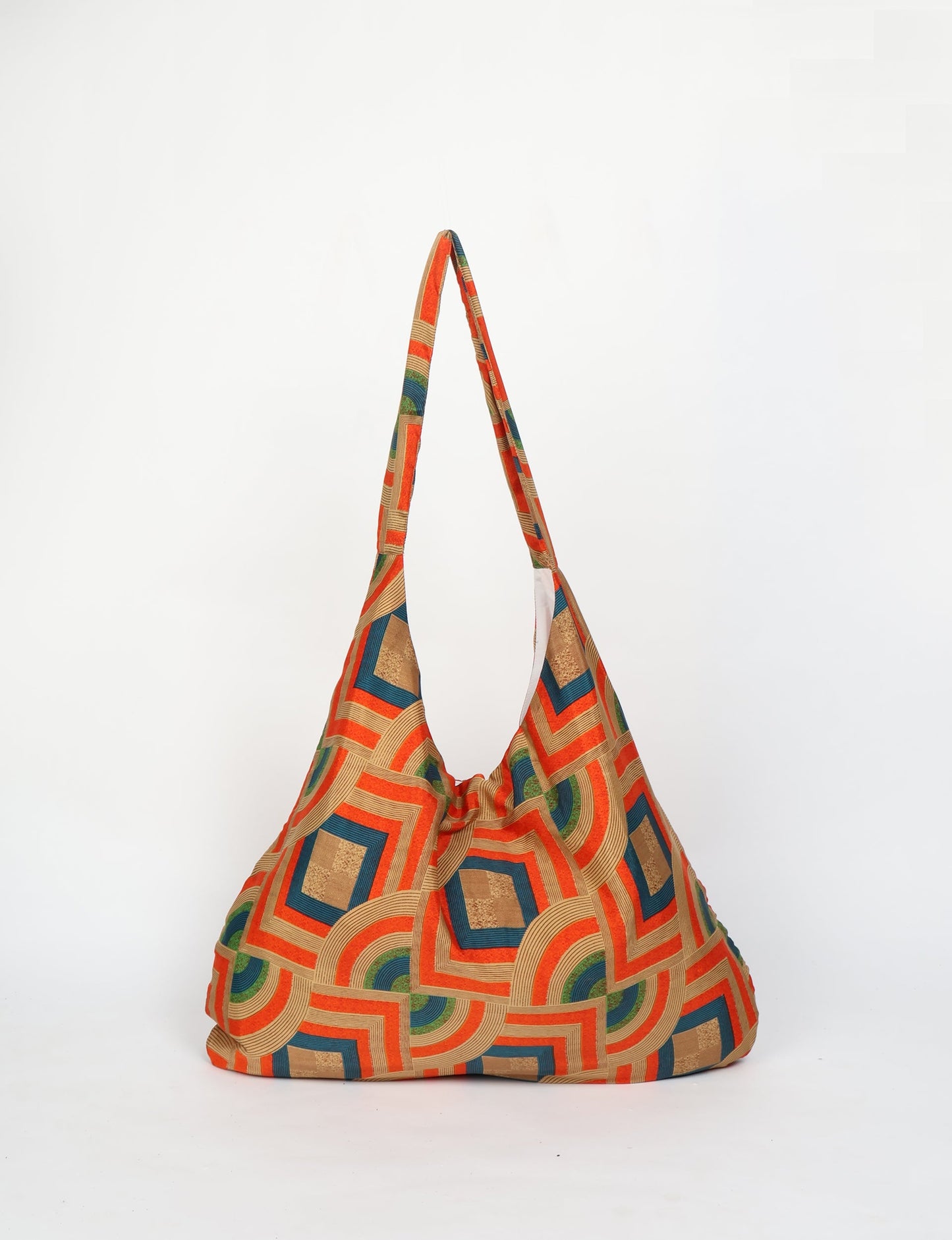 Trapeze bag made from repurposed sari fabric, featuring bold patterns and eco friendly cloth design—part of a sustainable women's clothing collection.