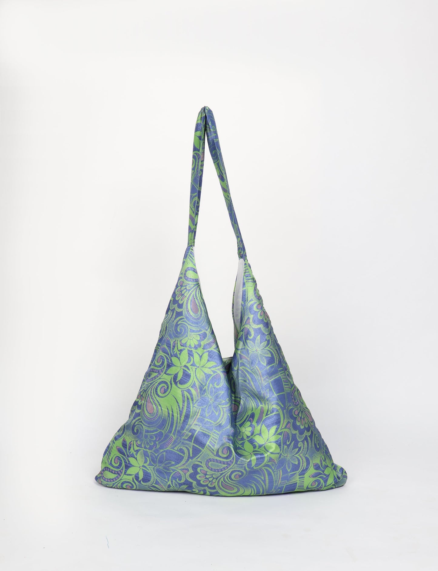 Trapeze bag made from repurposed sari fabric, featuring bold patterns and eco friendly cloth design—part of a sustainable women's clothing collection.