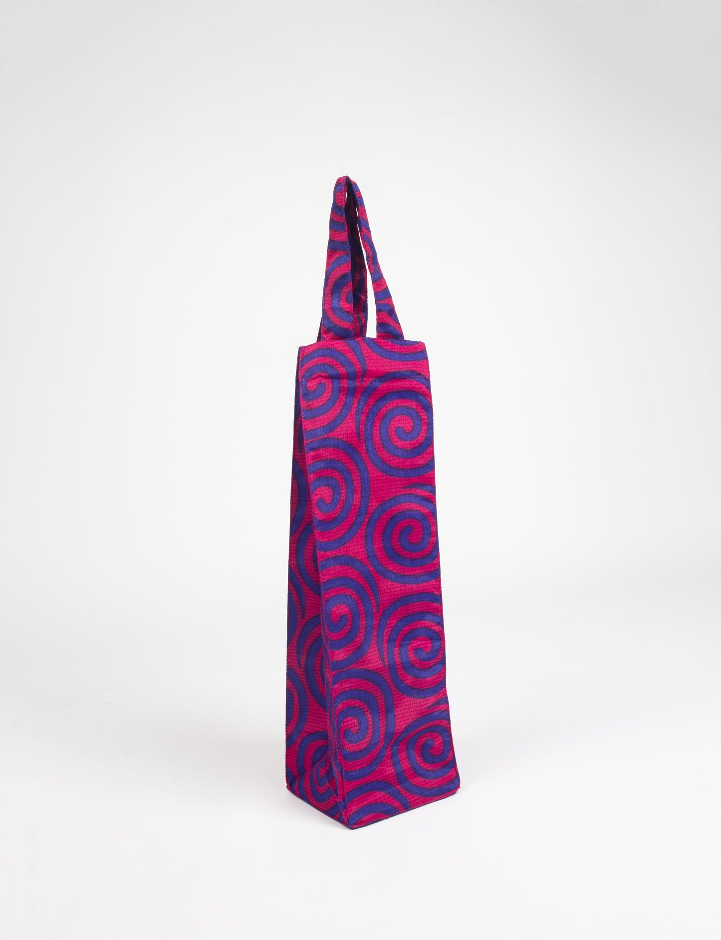 Indulge in eco-conscious wine storage with our Wine Bags, handcrafted from pre-loved saris by Mumbai craftswomen. Sturdy and stylish, these rectangular bags with small handles ensure a leak-free, eco-friendly solution for carrying and storing regular and sparkling wine bottles.