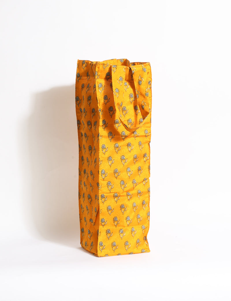 Indulge in eco-conscious wine storage with our Wine Bags, handcrafted from pre-loved saris by Mumbai craftswomen. Sturdy and stylish, these rectangular bags with small handles ensure a leak-free, eco-friendly solution for carrying and storing regular and sparkling wine bottles.