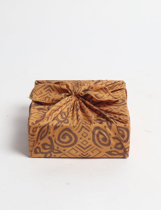 A delicately handcrafted wrap made from recycled sari offcuts, blending sustainable fashion with conscious design. This eco-friendly product showcases the beauty of upcycling and green fashion, making it a perfect accessory for those supporting circular fashion and products made from textile waste.