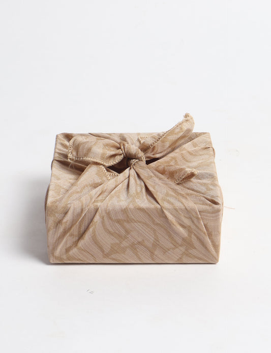 A delicately handcrafted wrap made from recycled sari offcuts, blending sustainable fashion with conscious design. This eco-friendly product showcases the beauty of upcycling and green fashion, making it a perfect accessory for those supporting circular fashion and products made from textile waste.