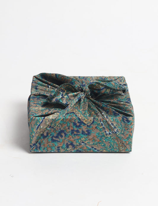 A delicately handcrafted wrap made from recycled sari offcuts, blending sustainable fashion with conscious design. This eco-friendly product showcases the beauty of upcycling and green fashion, making it a perfect accessory for those supporting circular fashion and products made from textile waste.