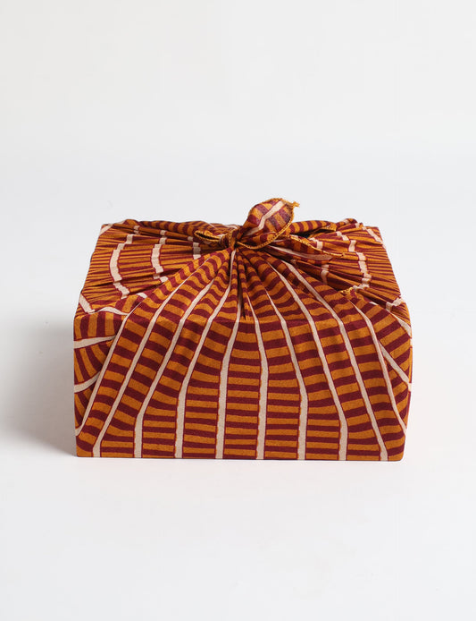 A delicately handcrafted wrap made from recycled sari offcuts, blending sustainable fashion with conscious design. This eco-friendly product showcases the beauty of upcycling and green fashion, making it a perfect accessory for those supporting circular fashion and products made from textile waste.