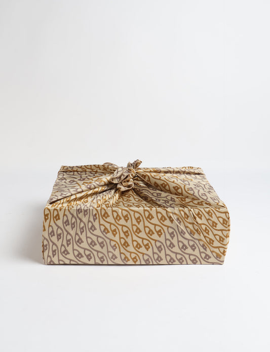 A delicately handcrafted wrap made from recycled sari offcuts, blending sustainable fashion with conscious design. This eco-friendly product showcases the beauty of upcycling and green fashion, making it a perfect accessory for those supporting circular fashion and products made from textile waste.