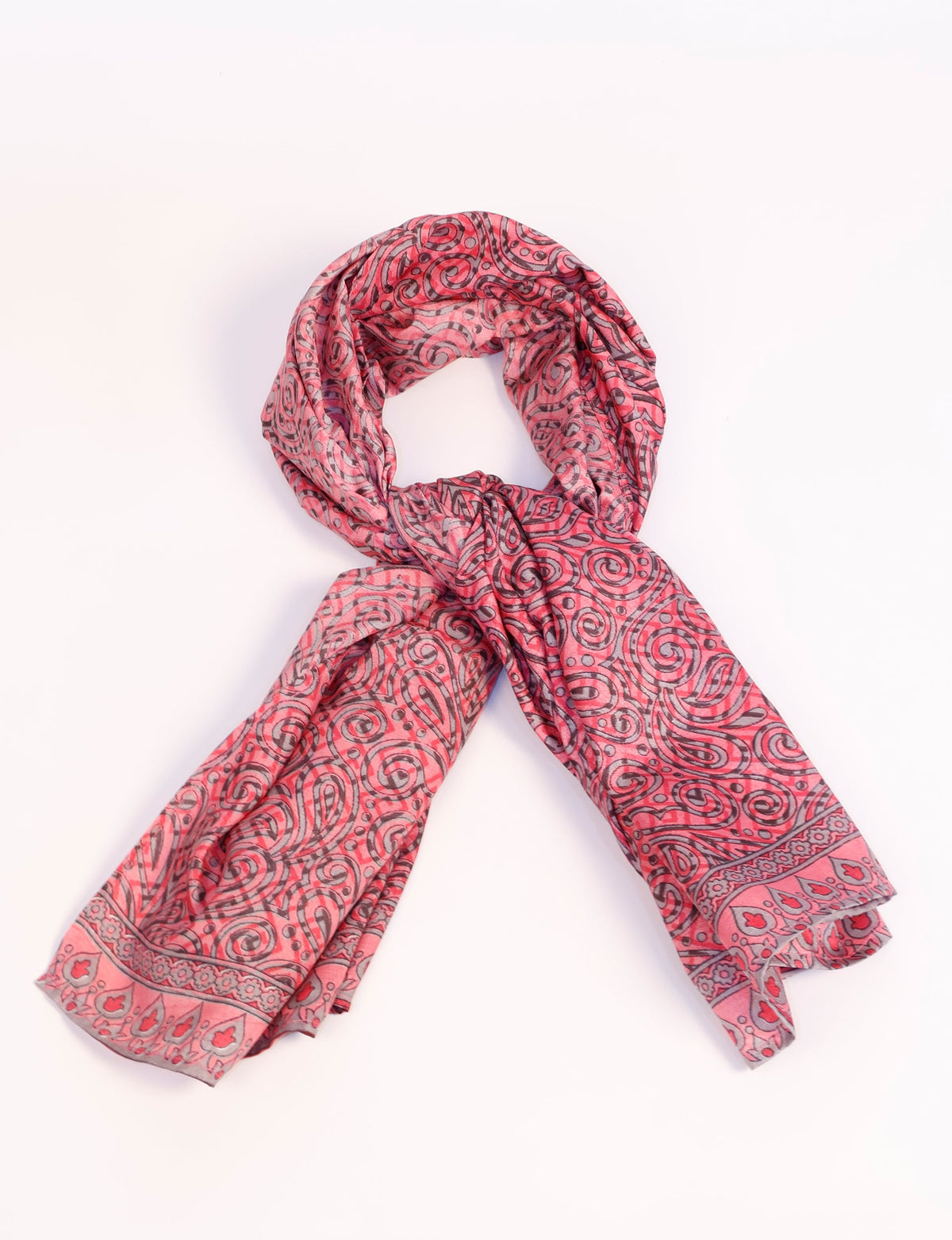 Pink foulard with black and gray swirling paisley and floral patterns, shown knotted on a white background
