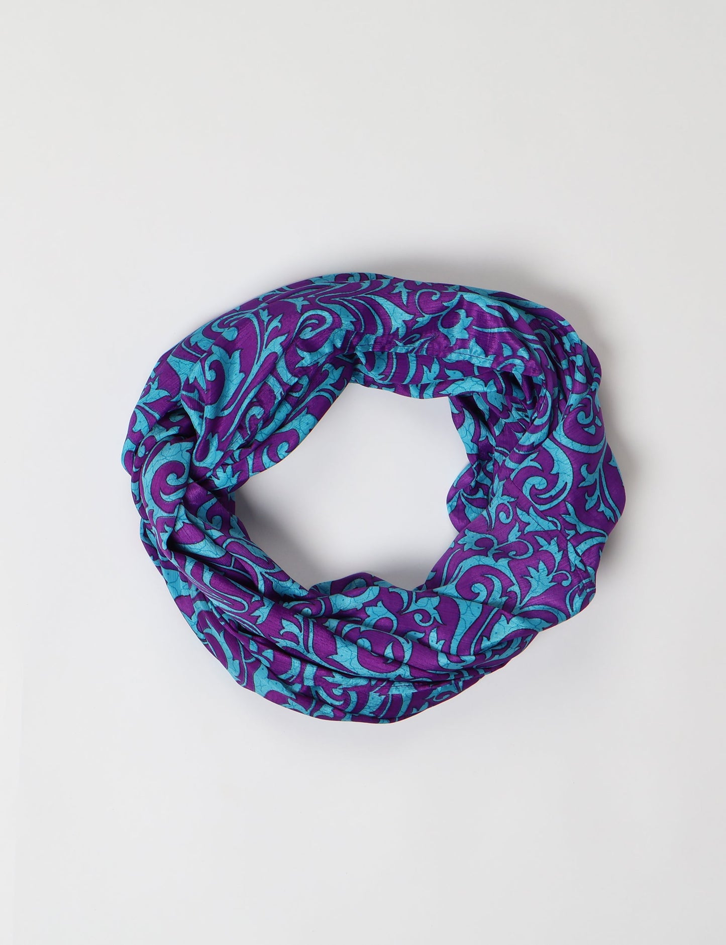 Sustainable style embraces you with our LOOP SCARF – an infinity-style scarf crafted from vibrant, pattern-rich saris. Handcrafted by experienced Mumbai-based artisans, this versatile scarf can be worn looped once or twice around your neck or as a head-wrap. From laid-back beach vacations to dress-to-impress dinners, this scarf is a timeless accessory.