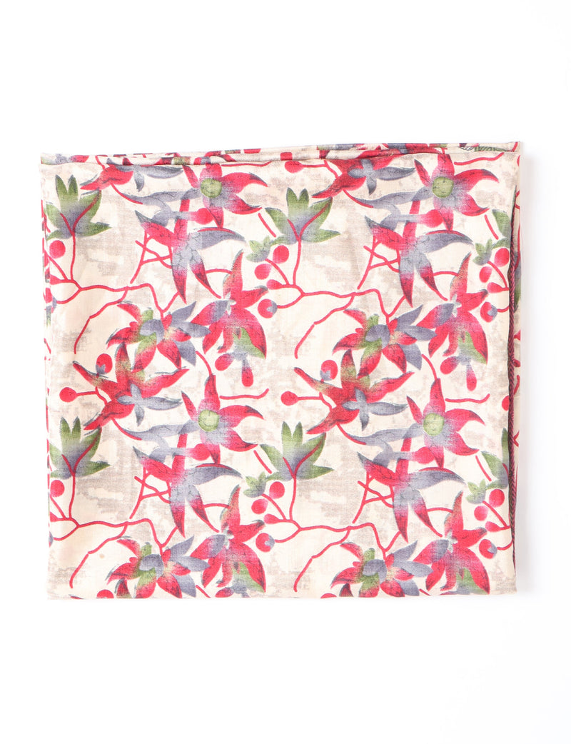 Beige pareo with red, green, and gray leaf and berry pattern, folded flat on white background