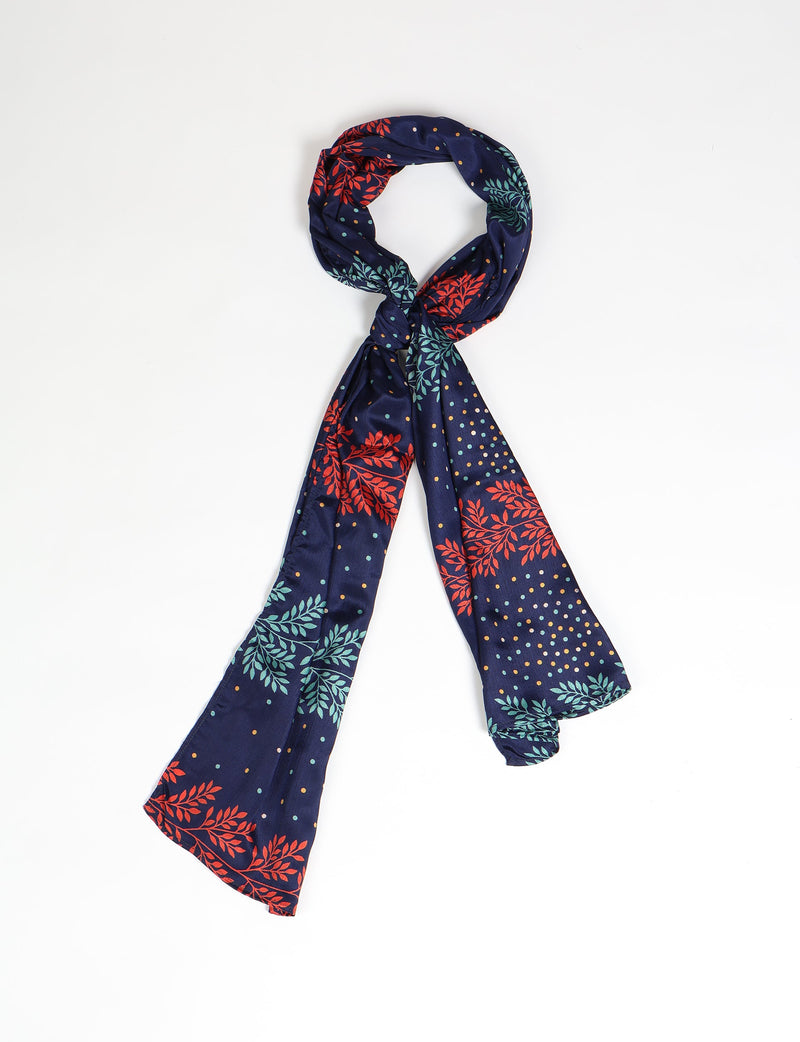 Navy blue stole with red and green floral leaf patterns and multicolored polka dots, shown knotted on white background