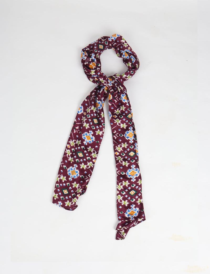 Purple stole with multicolor ethnic floral and geometric print, shown knotted on a white background