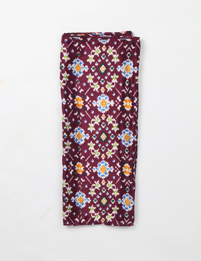 Folded purple stole with multicolor ethnic geometric patterns in blue, orange, green, and white on a white background