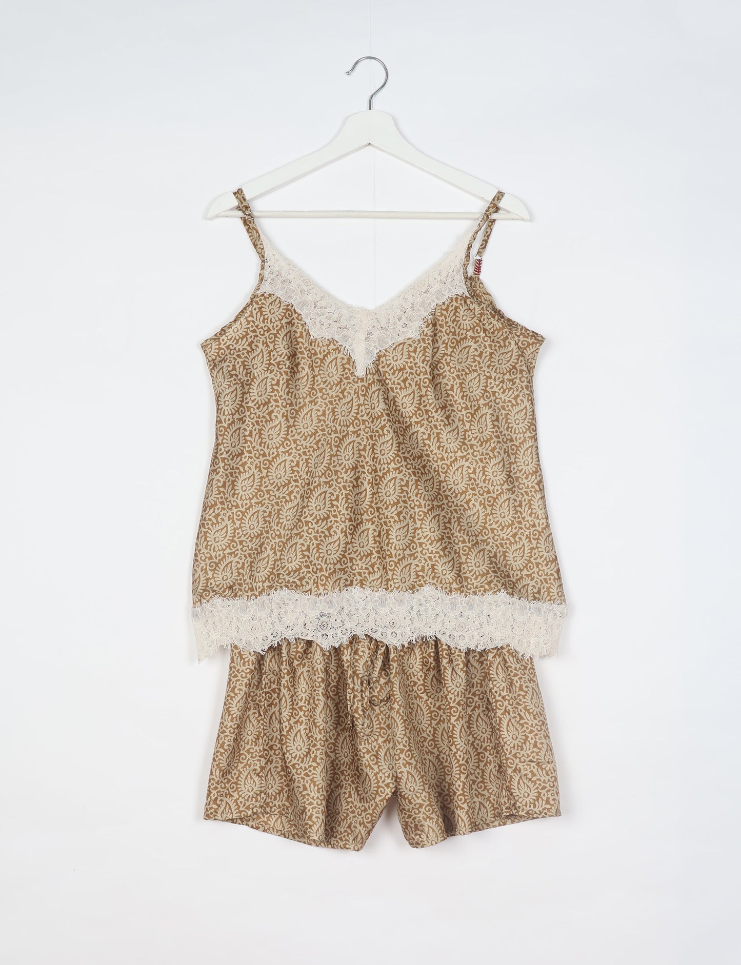 Sleep in eco-friendly luxury with our PJ Set Short. Made for the conscious consumer, these pajamas contribute to zero waste and sustainable practices. The cami top, adorned with delicate eyelash lace and cut on the bias, pairs seamlessly with the comfy shorts featuring an elasticated waist and drawstring tie.