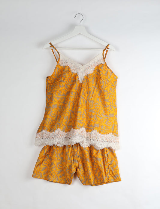 Sleep in eco-friendly luxury with our PJ Set Short. Made for the conscious consumer, these pajamas contribute to zero waste and sustainable practices. The cami top, adorned with delicate eyelash lace and cut on the bias, pairs seamlessly with the comfy shorts featuring an elasticated waist and drawstring tie.