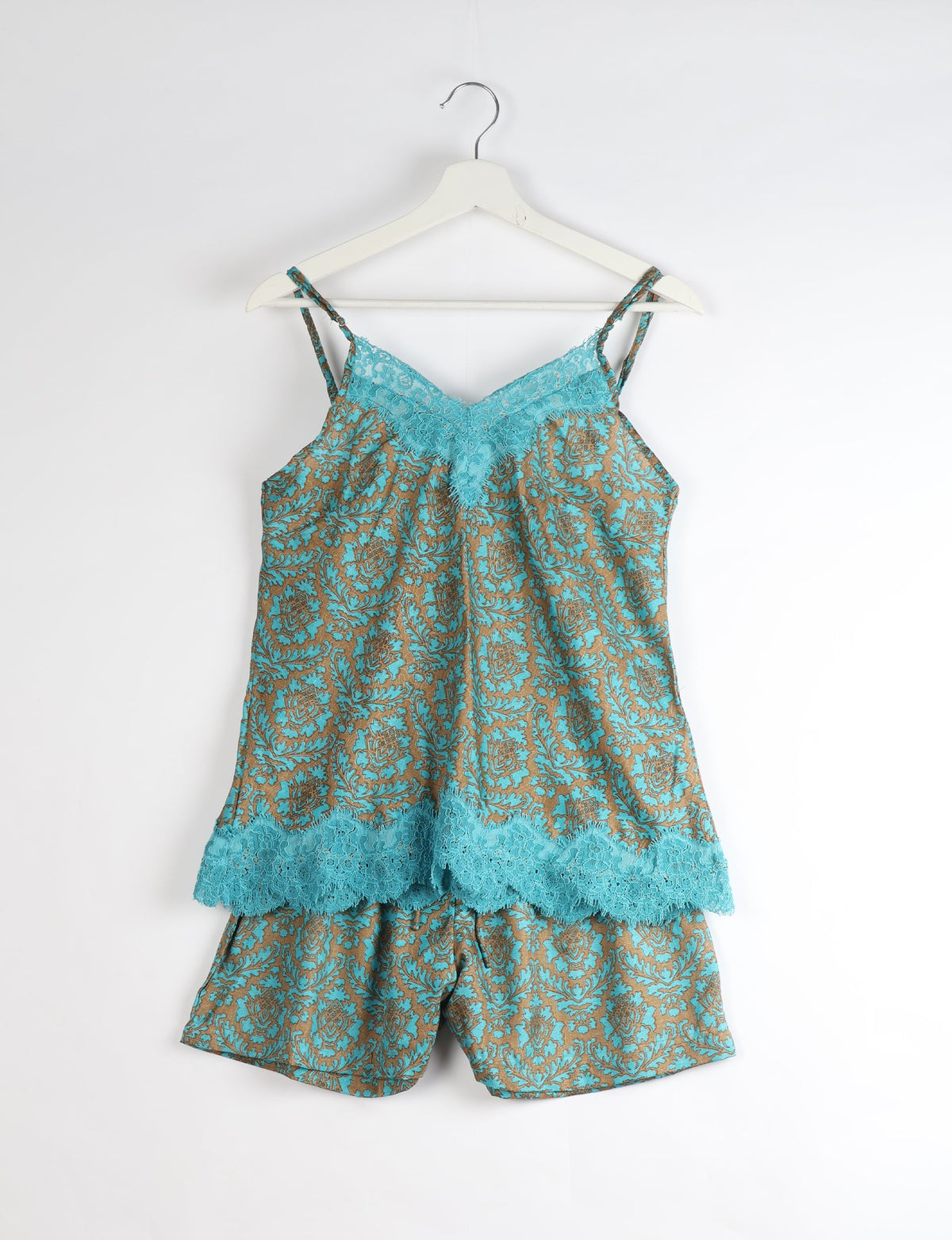 Sleep in eco-friendly luxury with our PJ Set Short. Made for the conscious consumer, these pajamas contribute to zero waste and sustainable practices. The cami top, adorned with delicate eyelash lace and cut on the bias, pairs seamlessly with the comfy shorts featuring an elasticated waist and drawstring tie.