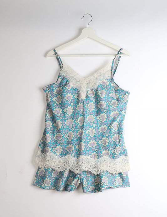 Sleep in eco-friendly luxury with our PJ Set Short. Made for the conscious consumer, these pajamas contribute to zero waste and sustainable practices. The cami top, adorned with delicate eyelash lace and cut on the bias, pairs seamlessly with the comfy shorts featuring an elasticated waist and drawstring tie.