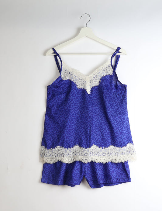 Sleep in eco-friendly luxury with our PJ Set Short. Made for the conscious consumer, these pajamas contribute to zero waste and sustainable practices. The cami top, adorned with delicate eyelash lace and cut on the bias, pairs seamlessly with the comfy shorts featuring an elasticated waist and drawstring tie.