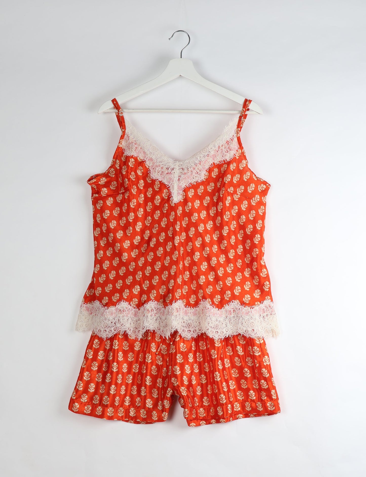 Sleep in eco-friendly luxury with our PJ Set Short. Made for the conscious consumer, these pajamas contribute to zero waste and sustainable practices. The cami top, adorned with delicate eyelash lace and cut on the bias, pairs seamlessly with the comfy shorts featuring an elasticated waist and drawstring tie.