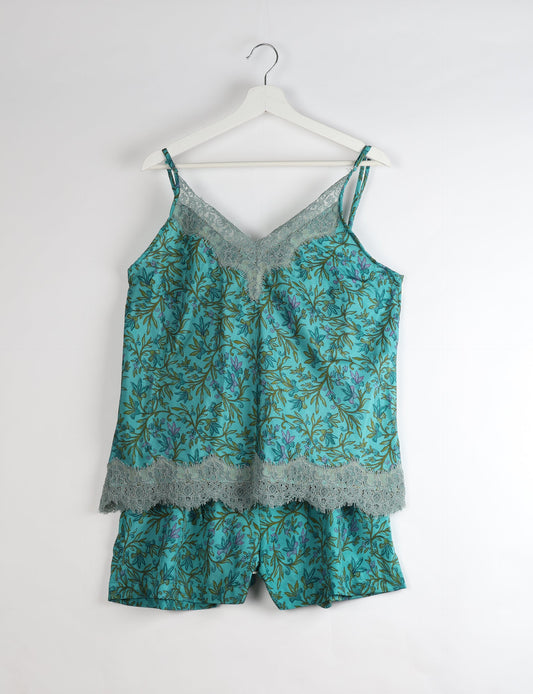 Sleep in eco-friendly luxury with our PJ Set Short. Made for the conscious consumer, these pajamas contribute to zero waste and sustainable practices. The cami top, adorned with delicate eyelash lace and cut on the bias, pairs seamlessly with the comfy shorts featuring an elasticated waist and drawstring tie.