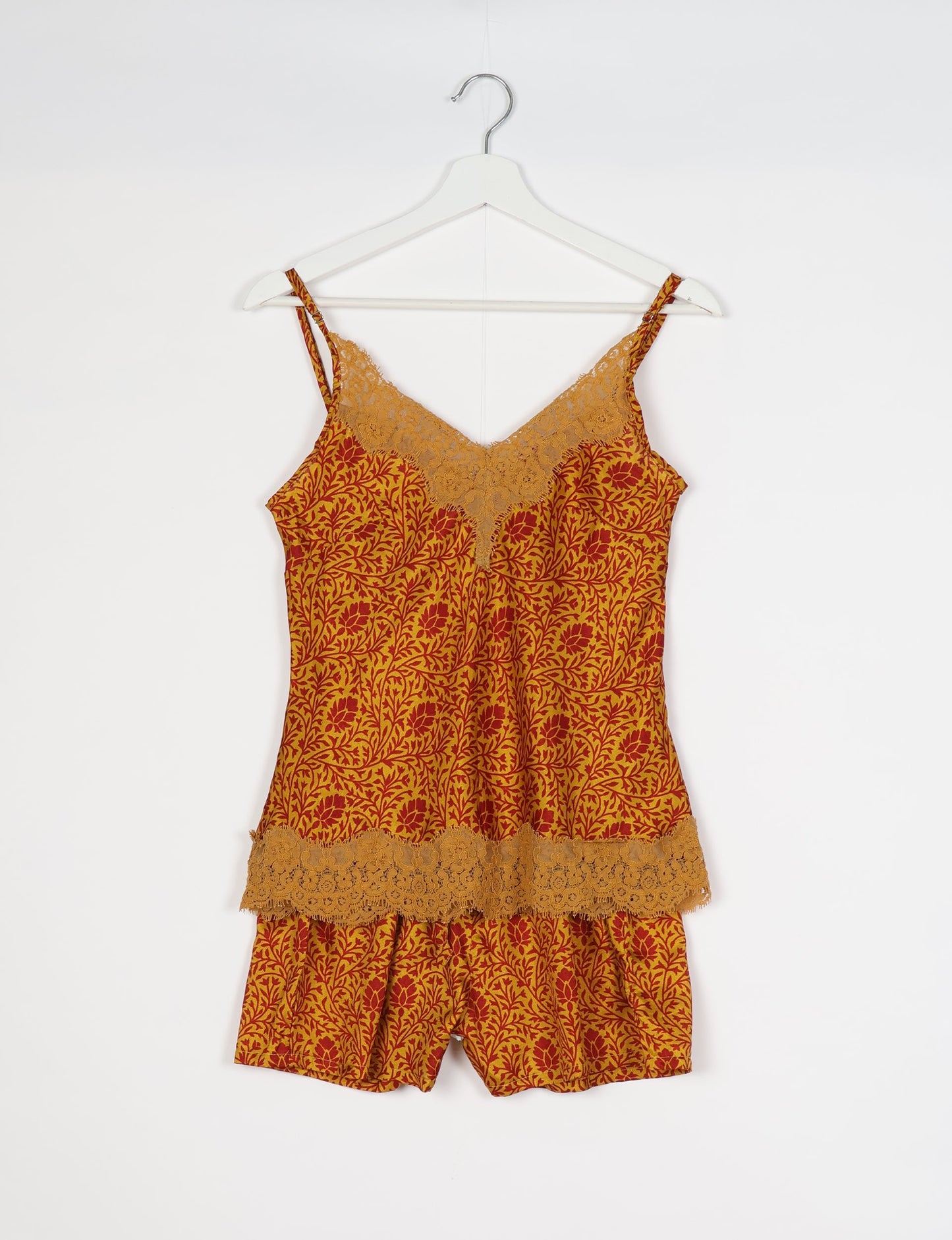 Sleep in eco-friendly luxury with our PJ Set Short. Made for the conscious consumer, these pajamas contribute to zero waste and sustainable practices. The cami top, adorned with delicate eyelash lace and cut on the bias, pairs seamlessly with the comfy shorts featuring an elasticated waist and drawstring tie.